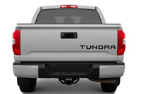 Back view of a silver 2014-2021 Toyota Tundra truck on a white background