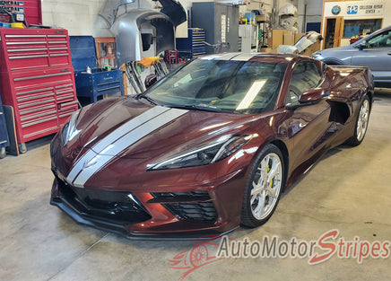 Maroon sports car Chevy Corvette C8 with white stripes in a garage setting, featuring 'AutoMotorStripes' branding.