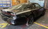 Black Dodge Charger with custom stripes in a garage setting, featuring 'AutoMotorStripes' branding. 2024-2026 Dodge Charger Recharge QP 24 Quarter Panels Factory Quality Mopar Vinyl Graphics 3M