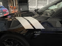Black Dodge Charger with white racing stripes in a garage setting. 2024-2026 Dodge Charger Double Bar 24 Stripes Hood Hash Marks Mopar Vinyl Graphics 3M Decals