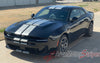 Black 2026 Dodge Charger Sixpack with white stripes on a driveway, featuring 'AutoMotorStripes' branding.