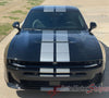 Black 2026 Dodge Charger Sixpack car with white racing stripes on a driveway, featuring 'AutoMotorStripes' branding.