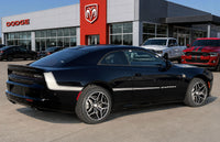 Black 2026 Dodge Charger car parked in front of a Dodge dealership with OEM style vinyl graphics striping and decals.