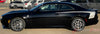 Black 2026 Dodge Charger Sixpack with side body vinyl graphics and stripes on a muscle car with white stripes on a road