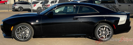 Black 2026 Dodge Charger Sixpack with side body vinyl graphics and stripes on a muscle car with white stripes on a road