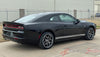Black 2024-2026 Dodge Charger Sixpack  muscle car parked on a concrete surface with a building in the background