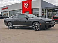 Black 2024-2026 Dodge Charger Sixpack car parked in front of a Dodge dealership