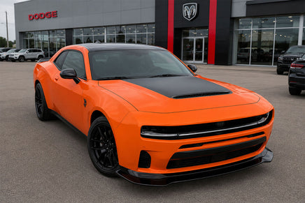 Orange 2026 Dodge Charger Sixpack car in front of a Dodge dealership