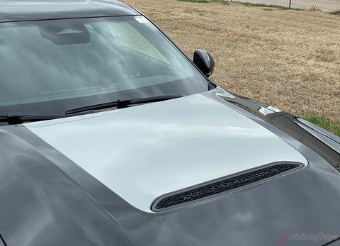 2026 Dodge Charger Sixpack Hood Stripes with a white cover and black air vents in an outdoor setting