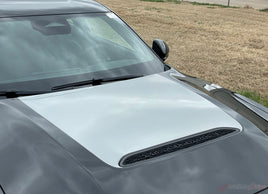2026 Dodge Charger Sixpack Hood Stripes with a white cover and black air vents in an outdoor setting