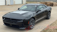 Black 2026 Dodge Charger Sixpack Hood Stripes parked on a concrete surface with a building and pallets in the background.