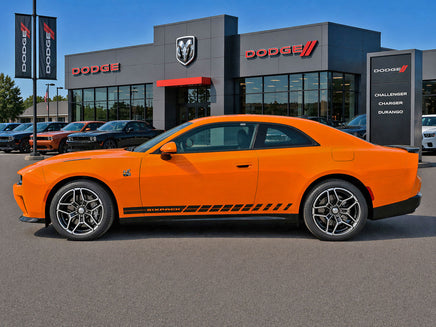 Orange 2024-2026 Dodge Charger Sixpack car parked in front of a Dodge dealership