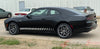 Black 2024-2026 Dodge Charger Sixpack with white racing stripes parked on a concrete surface.